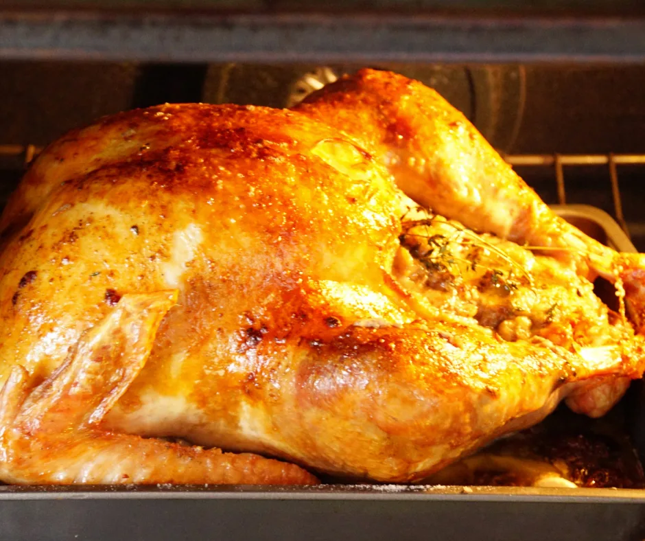 A turkey roasting in the oven. 