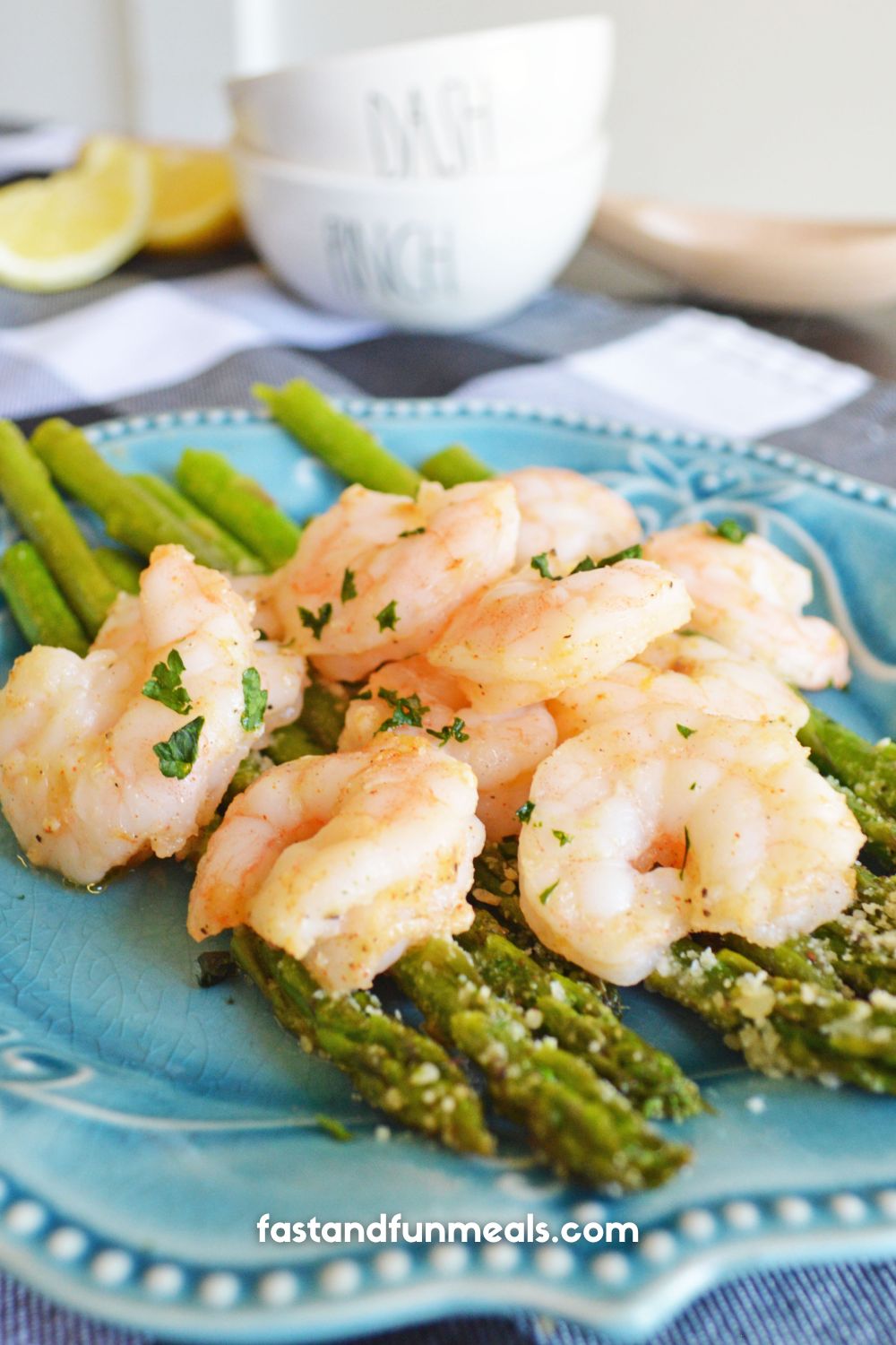 shrimp and asparagus completed dish on a blue plate