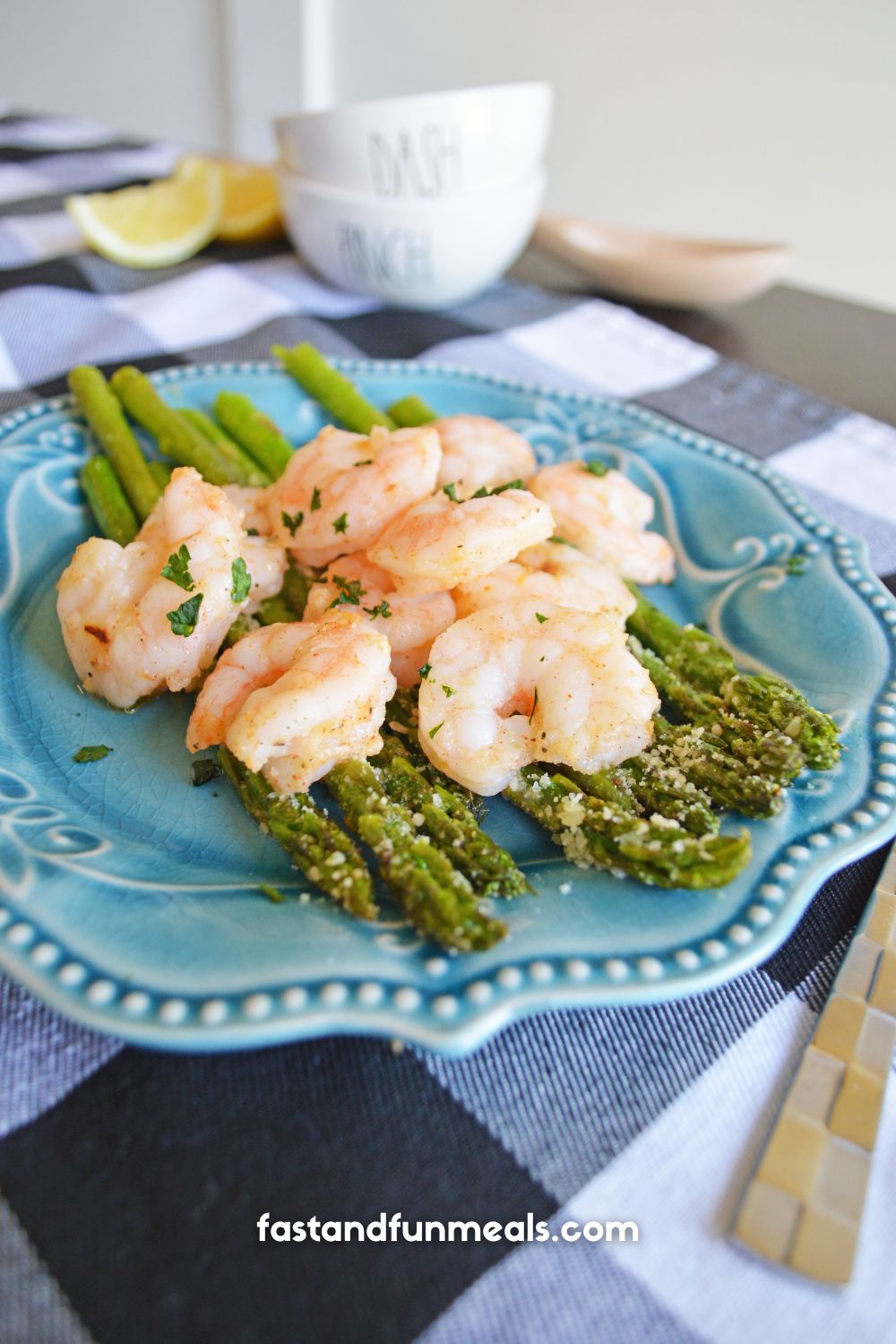 shrimp and asparagus completed dish on a blue plate