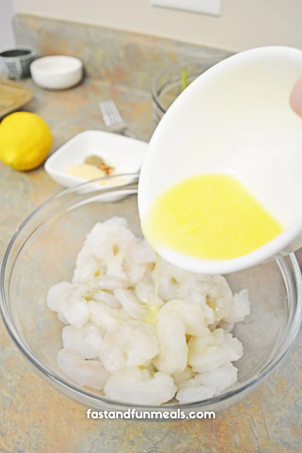 drizzle being poured on uncooked shrimp