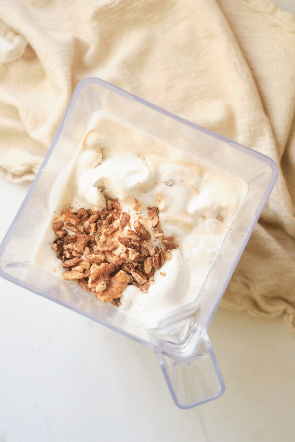 walnut smoothie with maple syrup and vanilla ice cream in a blender