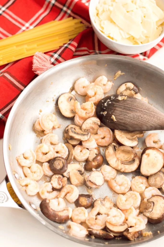 cooking mushrooms with garlic and butter for Shrimp Alfredo recipe
