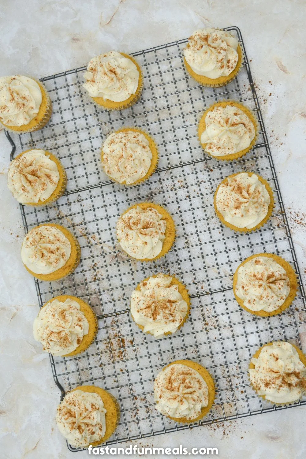Pumpkin Cupcakes with Cream Cheese Frosting on a cooling rack