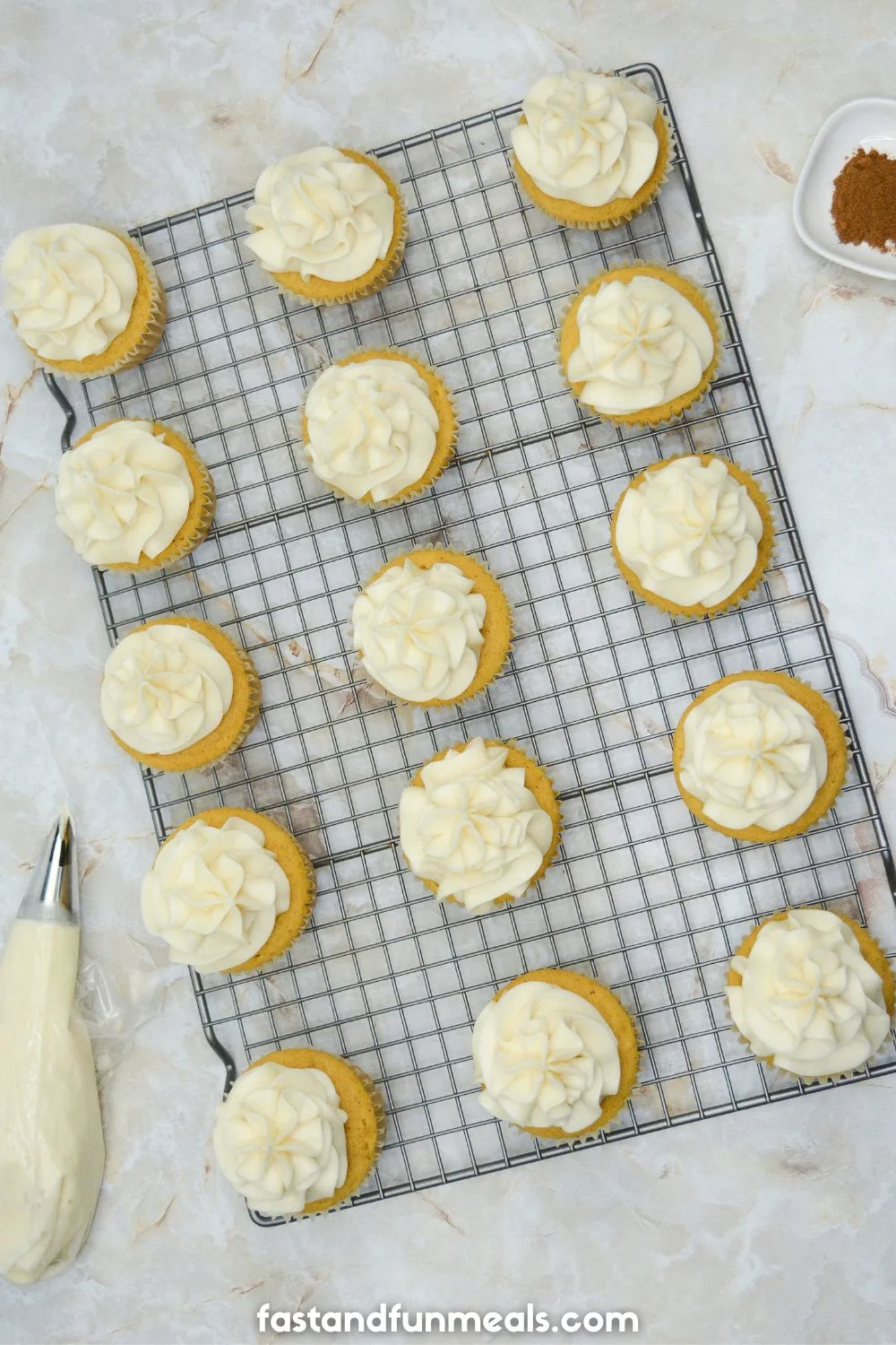 pumpkin cupcake iced with cream cheese frosting